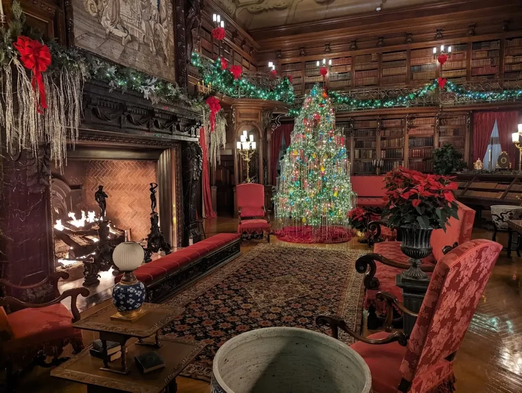 a room with a christmas tree and a fireplace